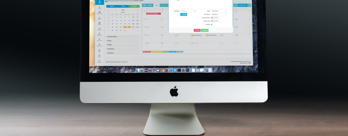 Silver Imac, Apple Magic Keyboard, and Magic Mouse on Wooden Table