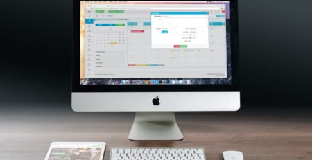 Silver Imac, Apple Magic Keyboard, and Magic Mouse on Wooden Table