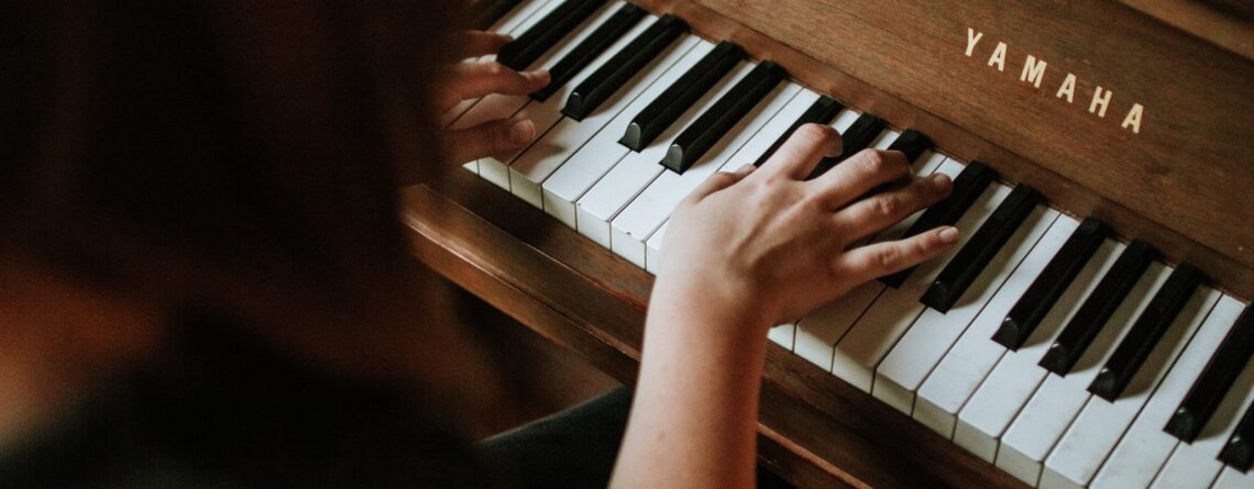 woman playing Yamaha piano