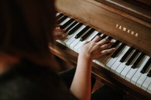 woman playing Yamaha piano