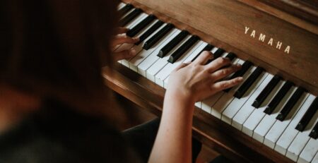 woman playing Yamaha piano