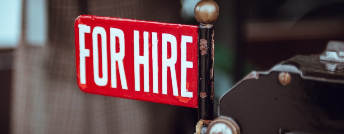 shallow focus photography of red and white for hire signage