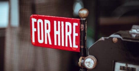 shallow focus photography of red and white for hire signage