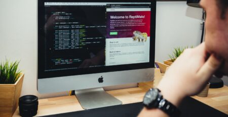 silver imac on brown wooden desk